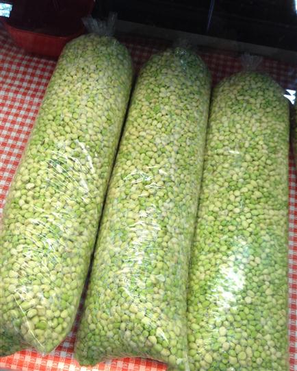 Bagged peas on a table with checkered table cloth