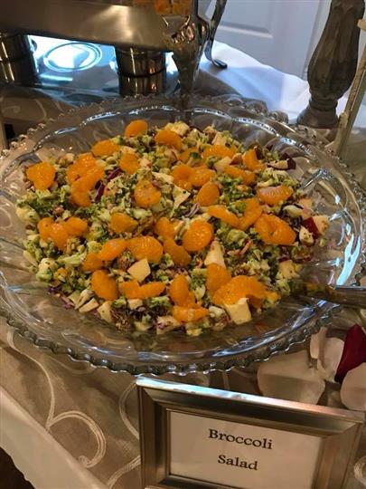 Broccoli salad in a glass bowl on a table