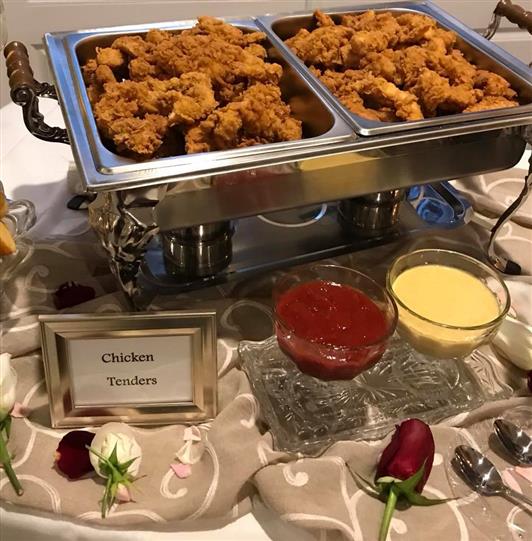 Fried Chicken tenders with dipping sauce in a stove on a table