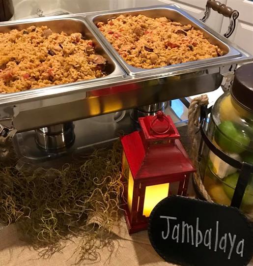 Jambalaya in two stoves on a table with a lantern decoration
