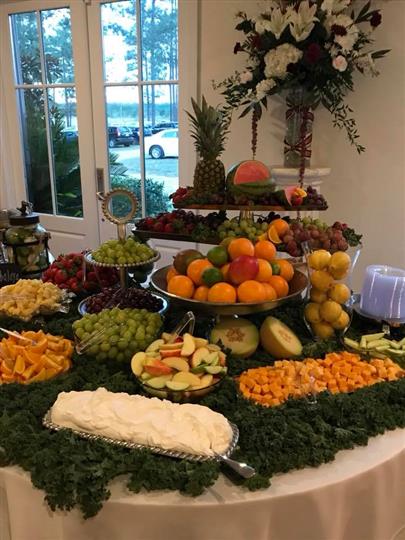 Fruits on a table on a display with cheeses and dips