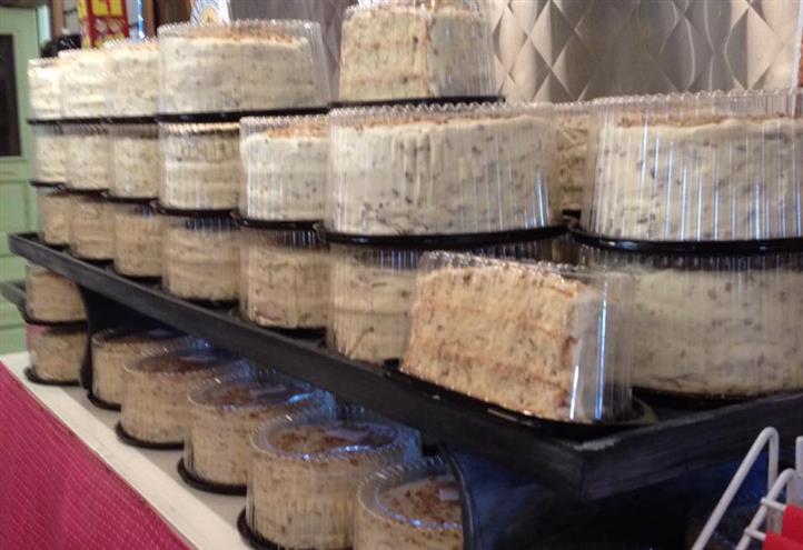 Multiple assorted cakes on a display stacked on each other