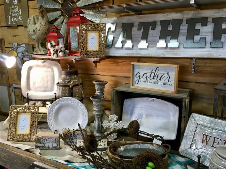 Plates, Picture frames, and candle holders on a display for sale