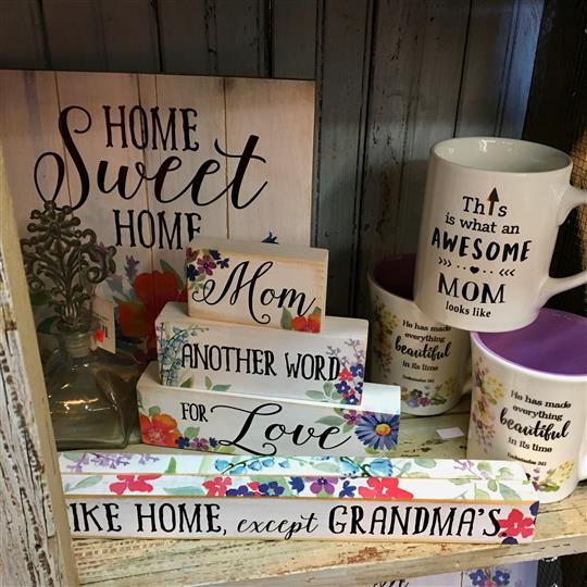 Signs and mugs for sale on a display