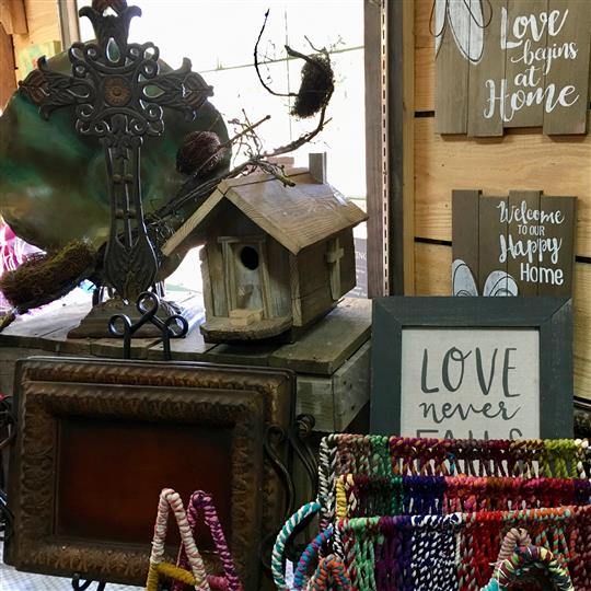 Bird house and signs for sale at a gift shop