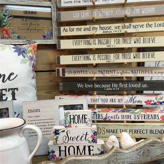 Multiple signs on display for sale and bird decorations