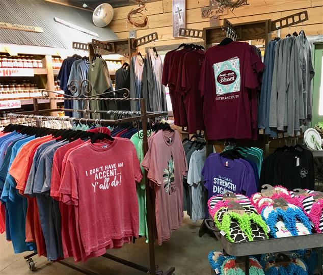 Multiple t shirts on display for sale in a store