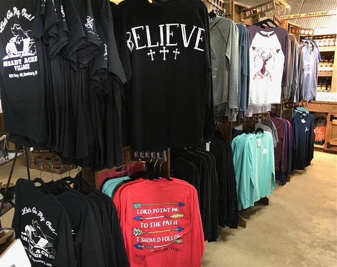 Multiple shirts for sale in a store