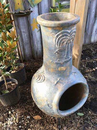Outdoor furnace decoration next to plants