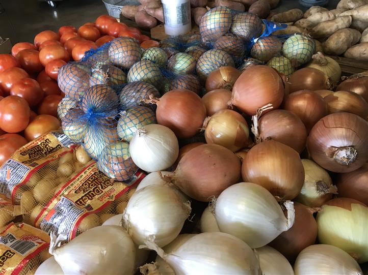 Bagged onions on a display for sale
