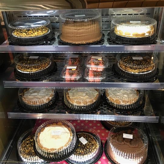 Assortment of pies and cakes on a display for sale