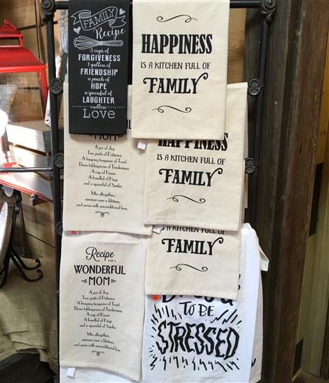 Multiple towels on a display that have messages.