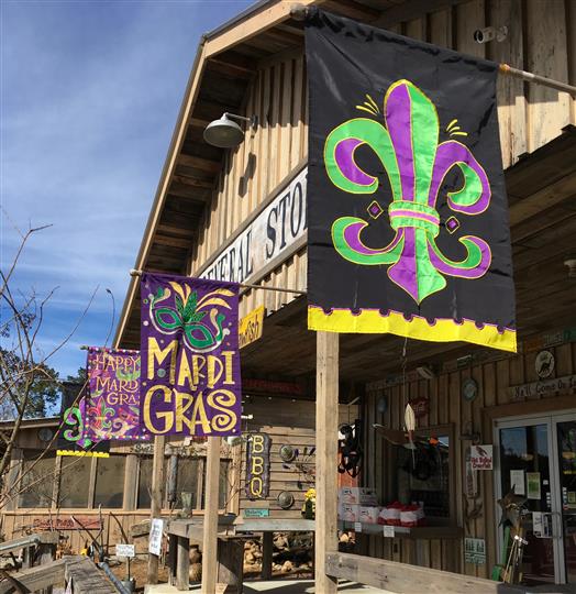 Front entrance of General store with mardi gras flags