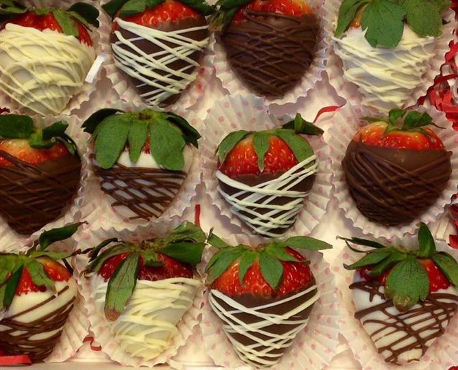 Chocolate dipped strawberries with laced chocolate over it.