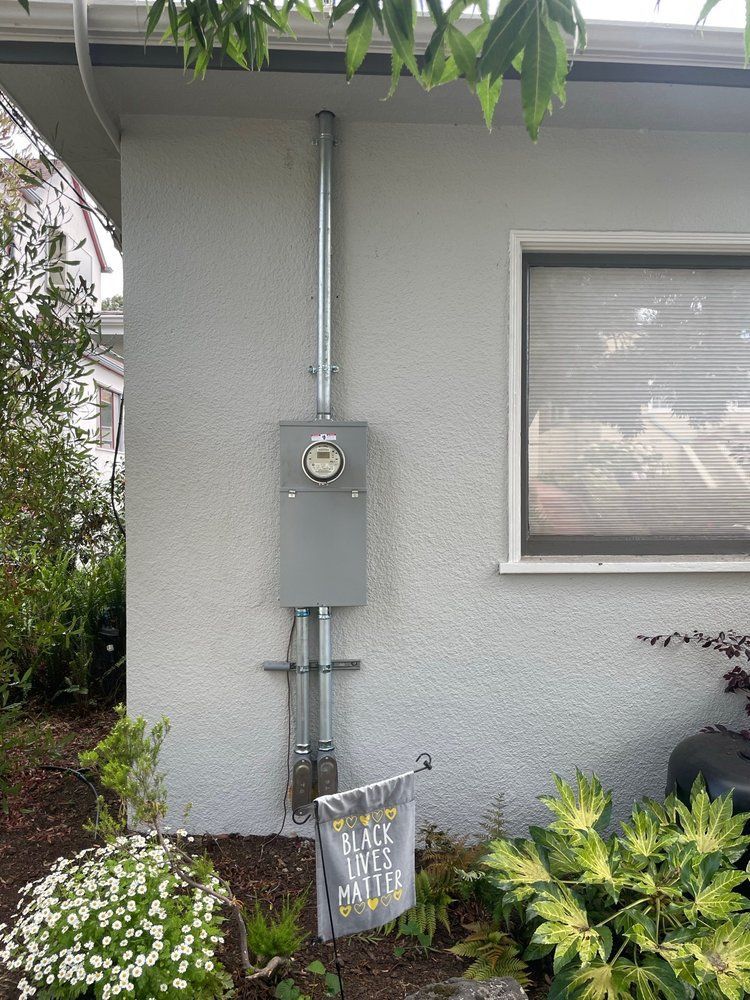 A house with a electrical box on the side of it.
