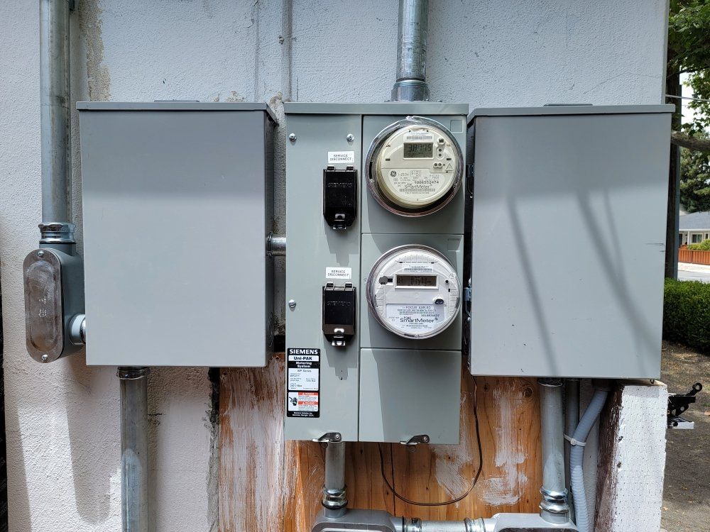 There is a meter on the side of a building.