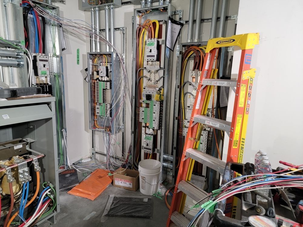 A room filled with lots of wires and a ladder.