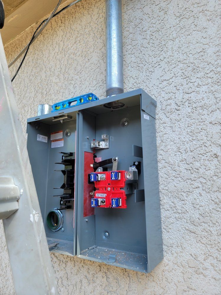 A ladder is sitting next to a box on a wall.