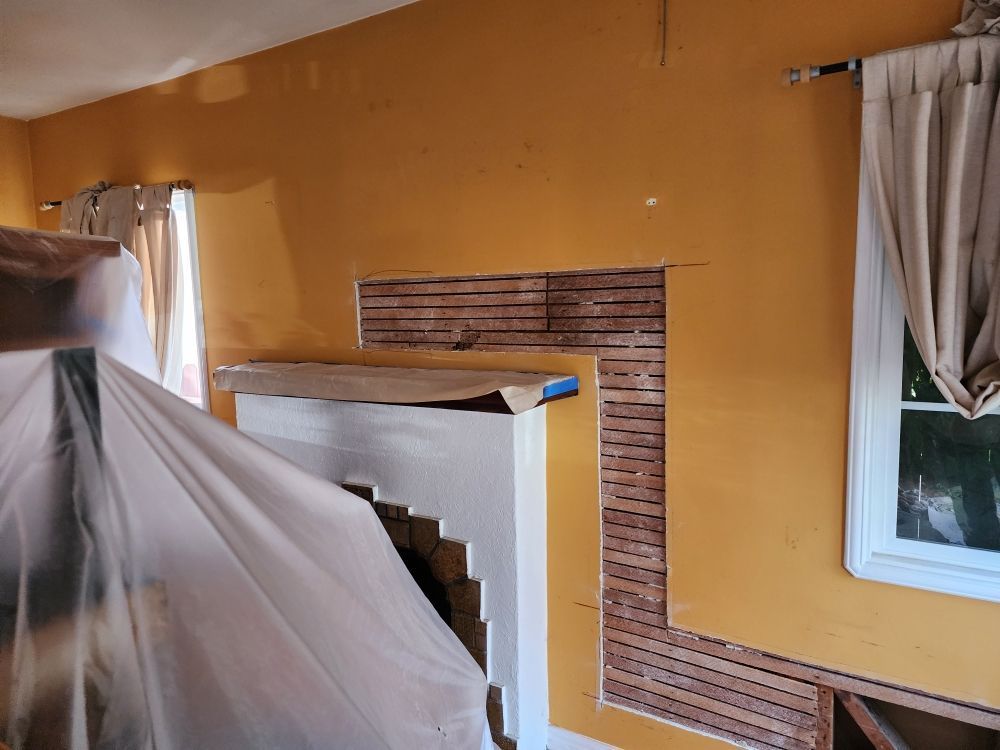 A room with yellow walls and a fireplace in it