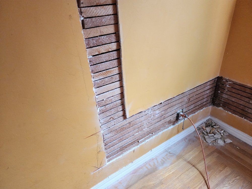 A room with a brick wall and a wooden floor.