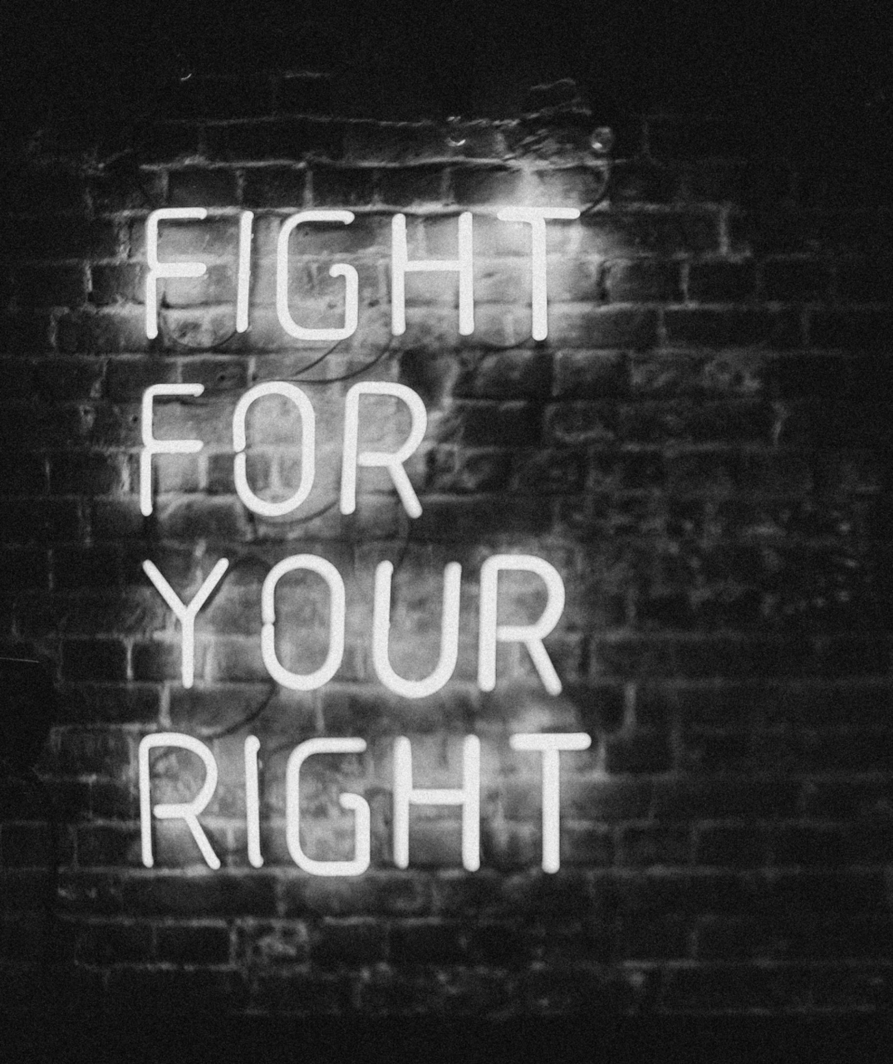 Looking up at a tall building with a blue sky in the background.