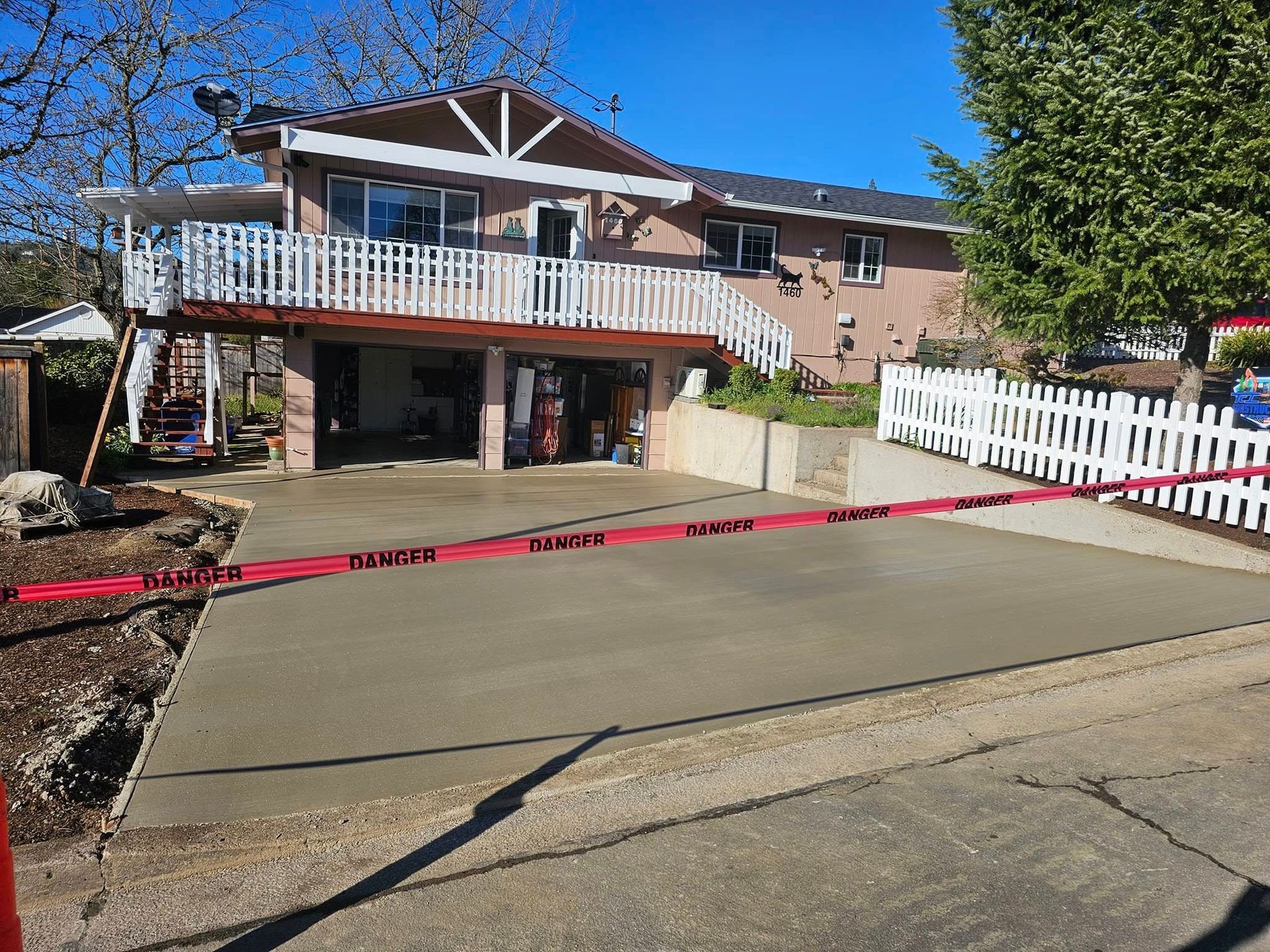 A large house with a concrete driveway in front of it