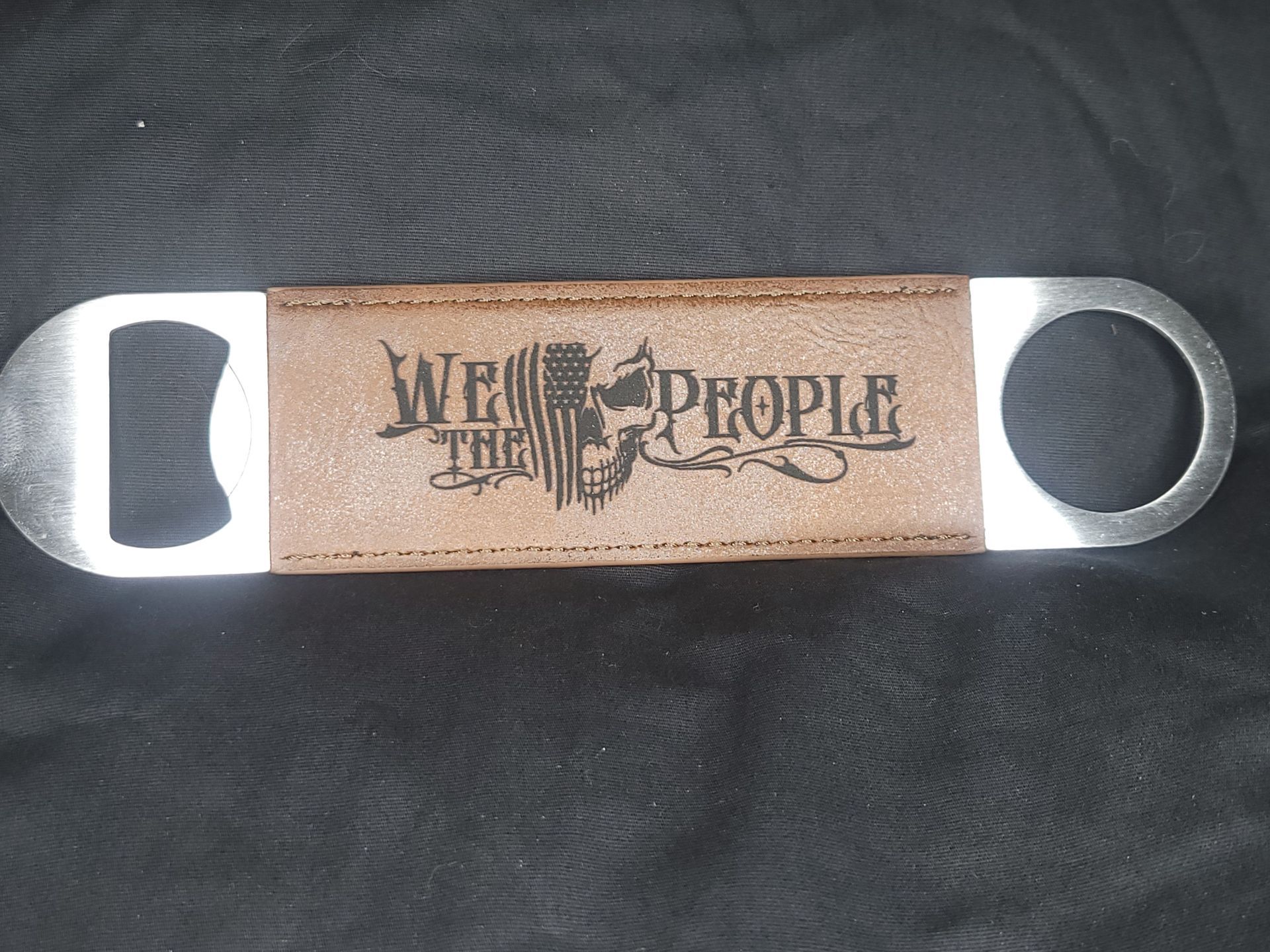 A bottle opener that says we the people on it
