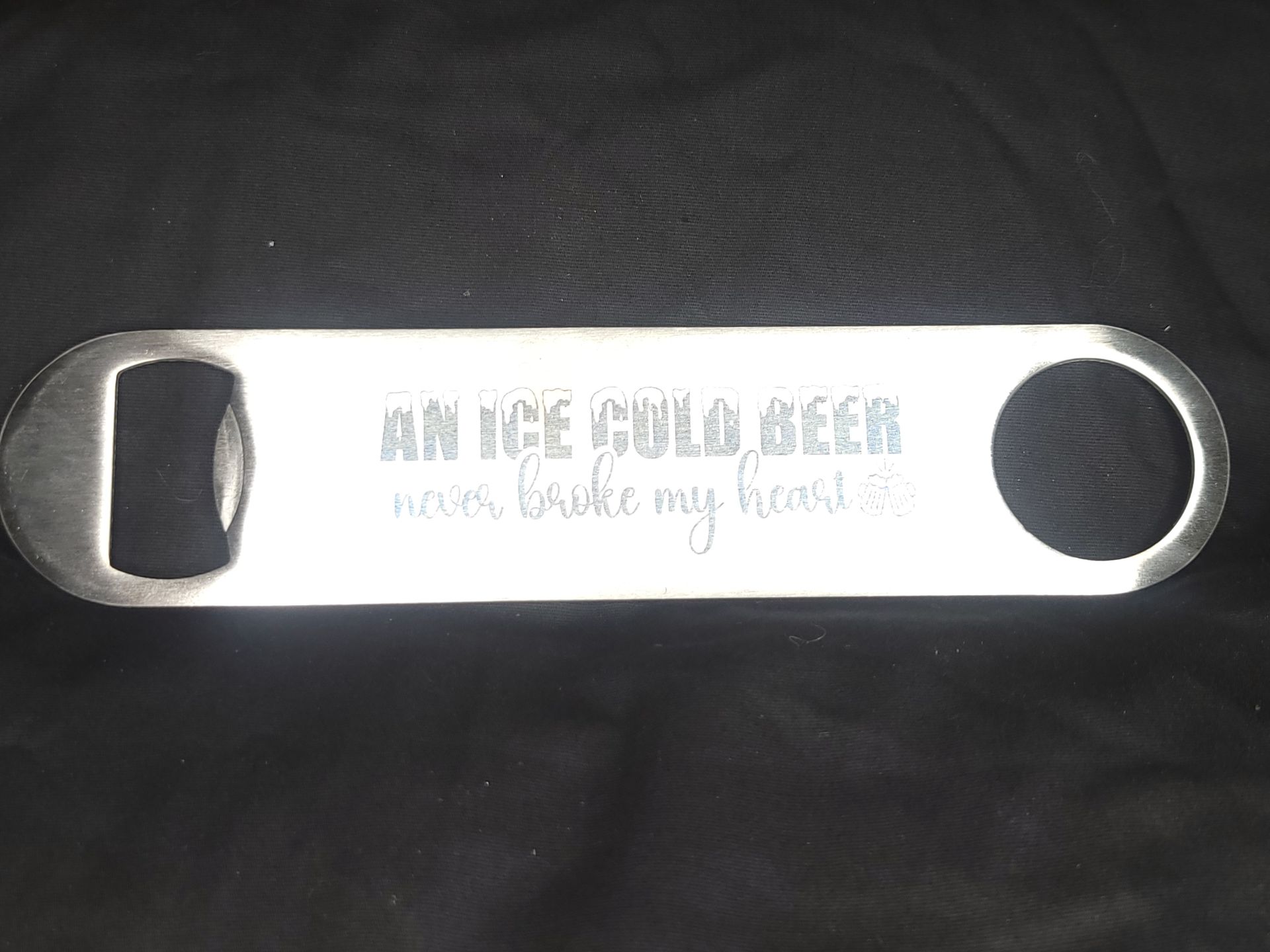 A bottle opener that says an ice cold beer never broke my head