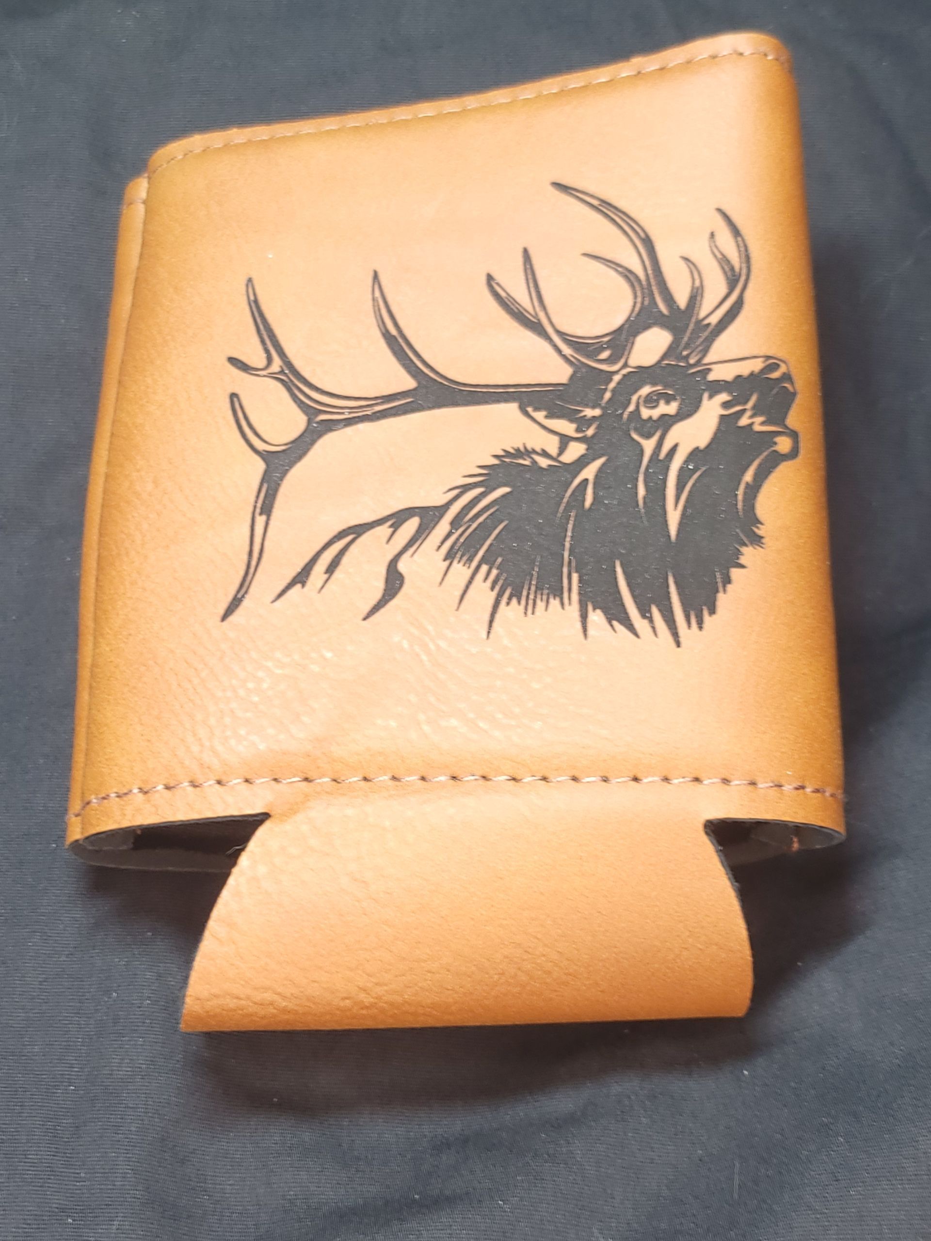 A brown leather wallet with a picture of a deer on it