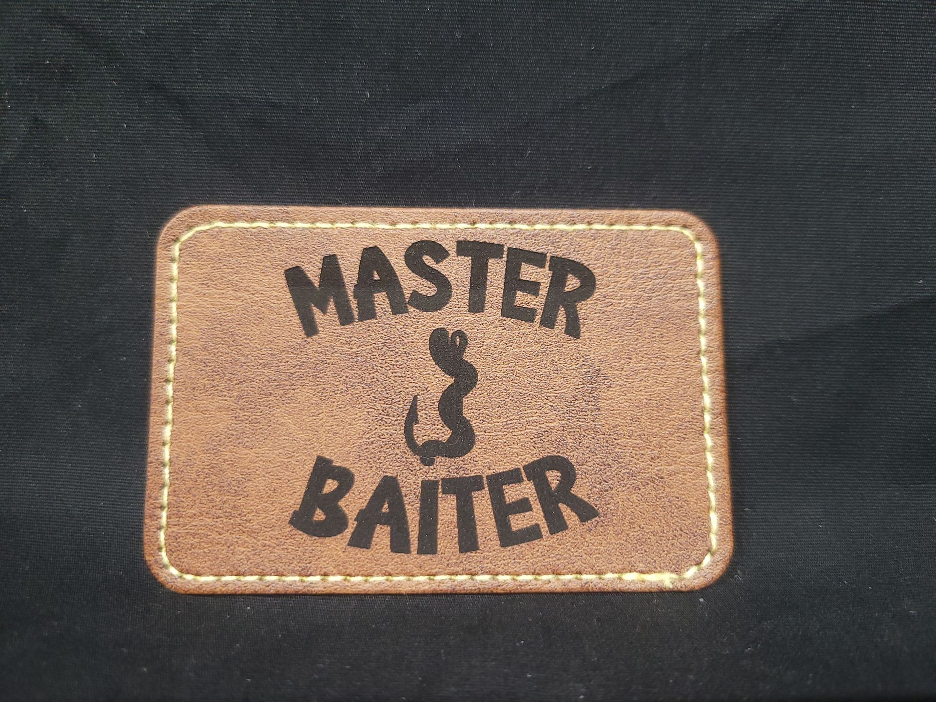 A patch that says master & baiter on it