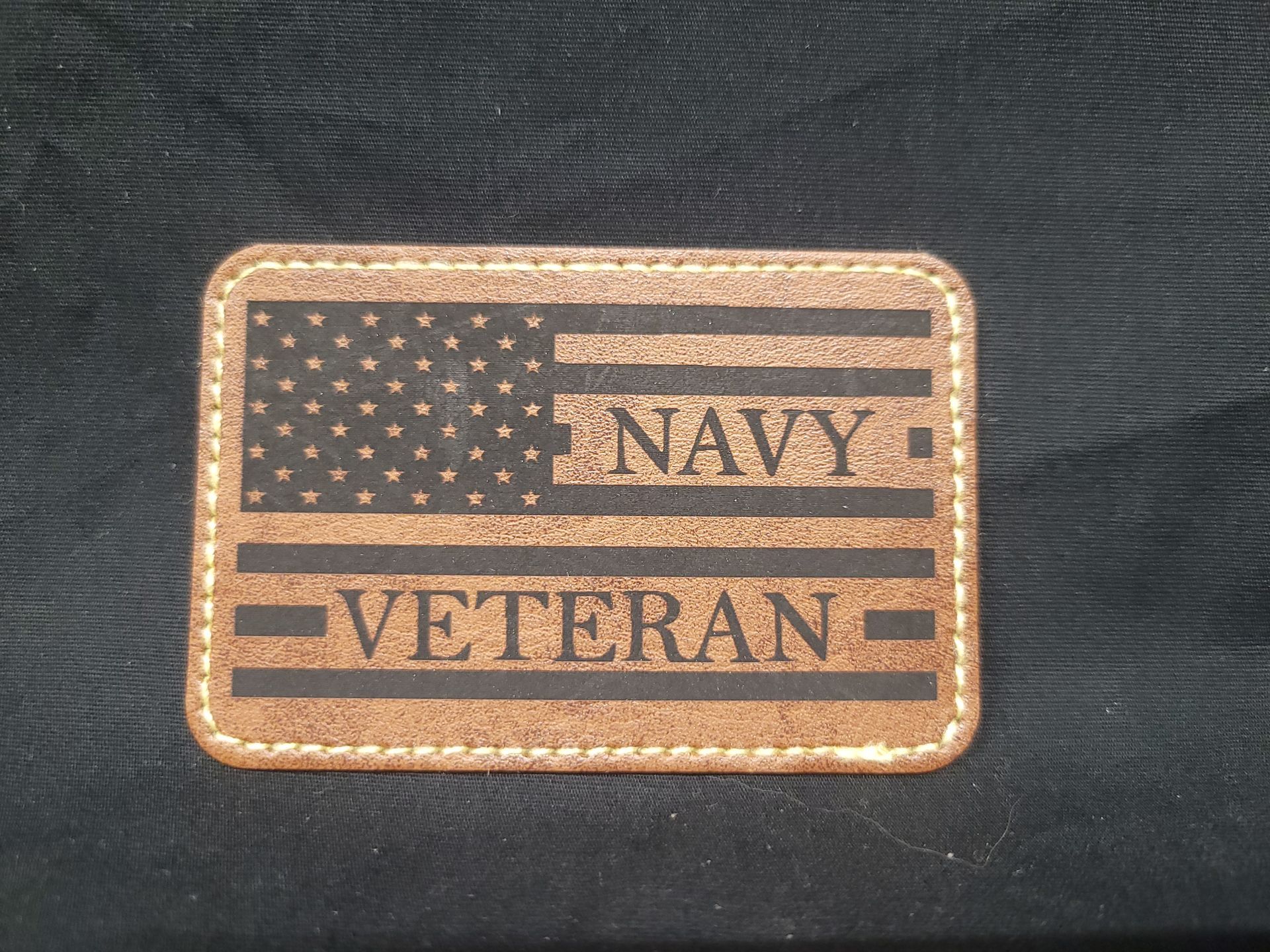 A patch that says navy veteran on it