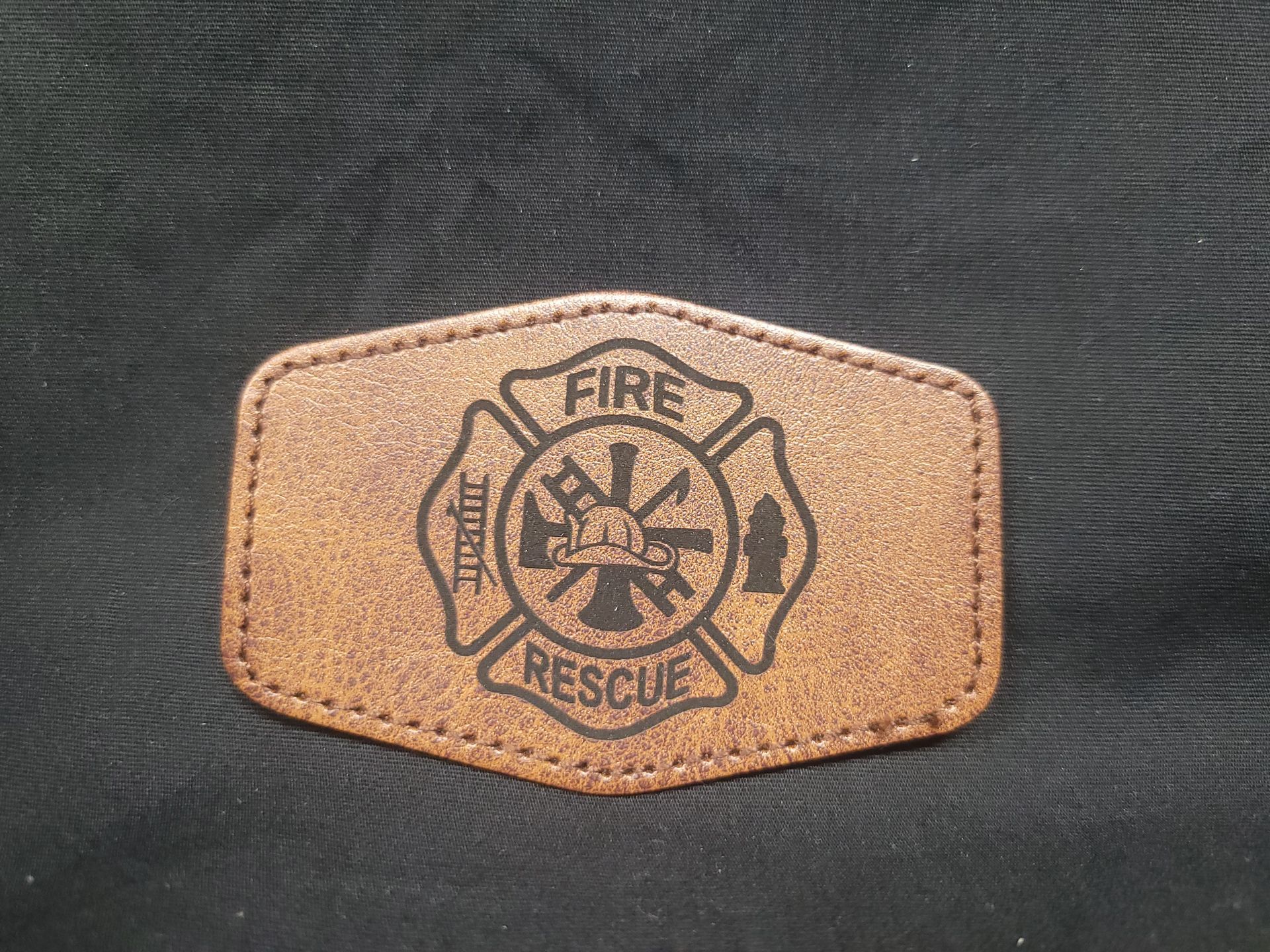 A brown leather patch that says fire rescue on it