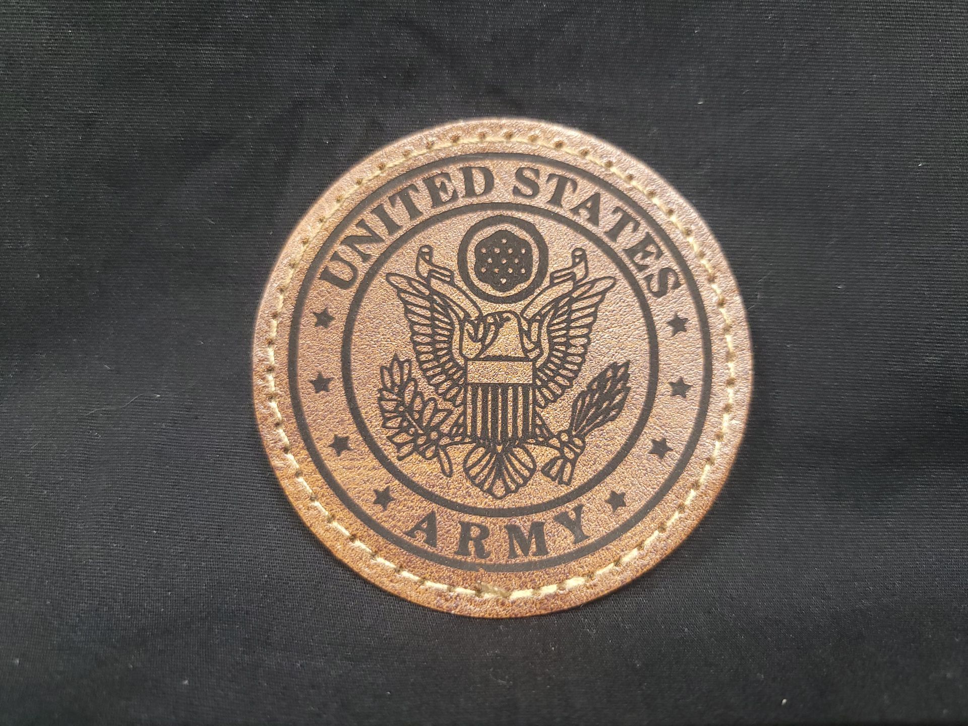 A united states army patch on a black cloth