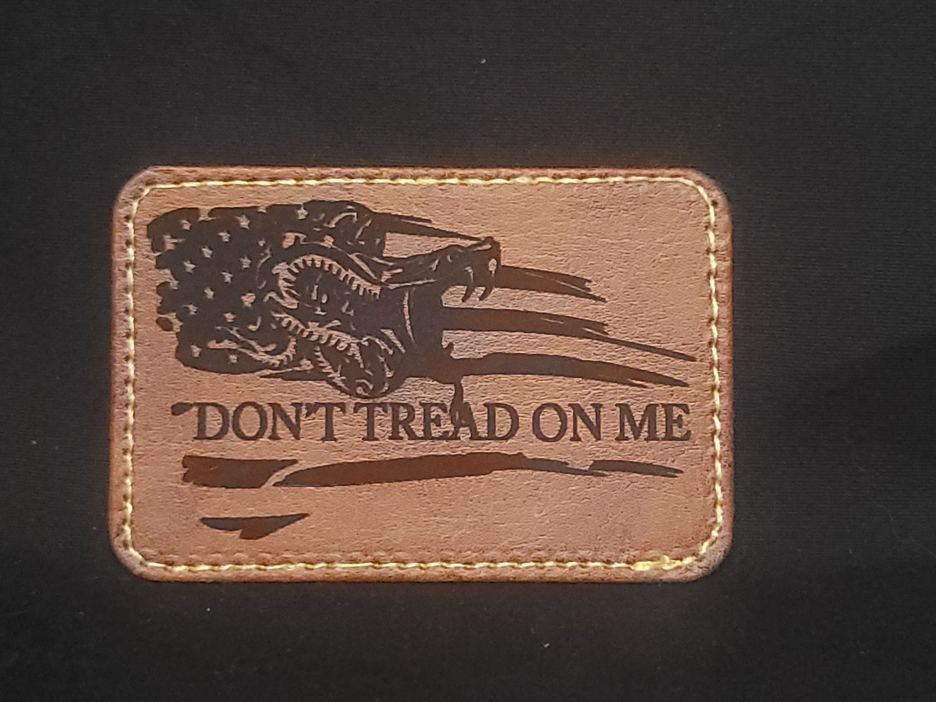 A brown leather patch that says