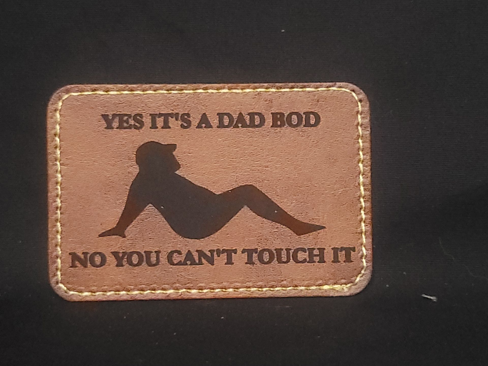 A patch that says yes it 's a dad bod no you can 't touch it