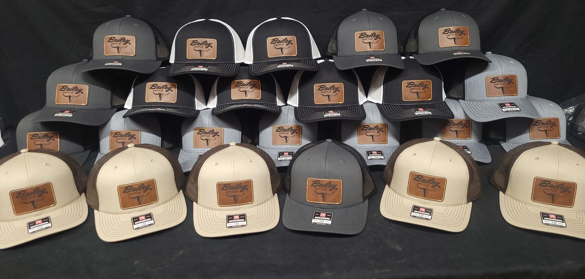 A bunch of hats are lined up on a table.