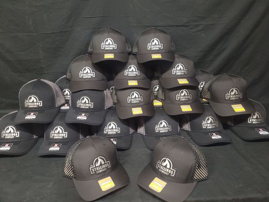 A group of hats are stacked on top of each other on a table.