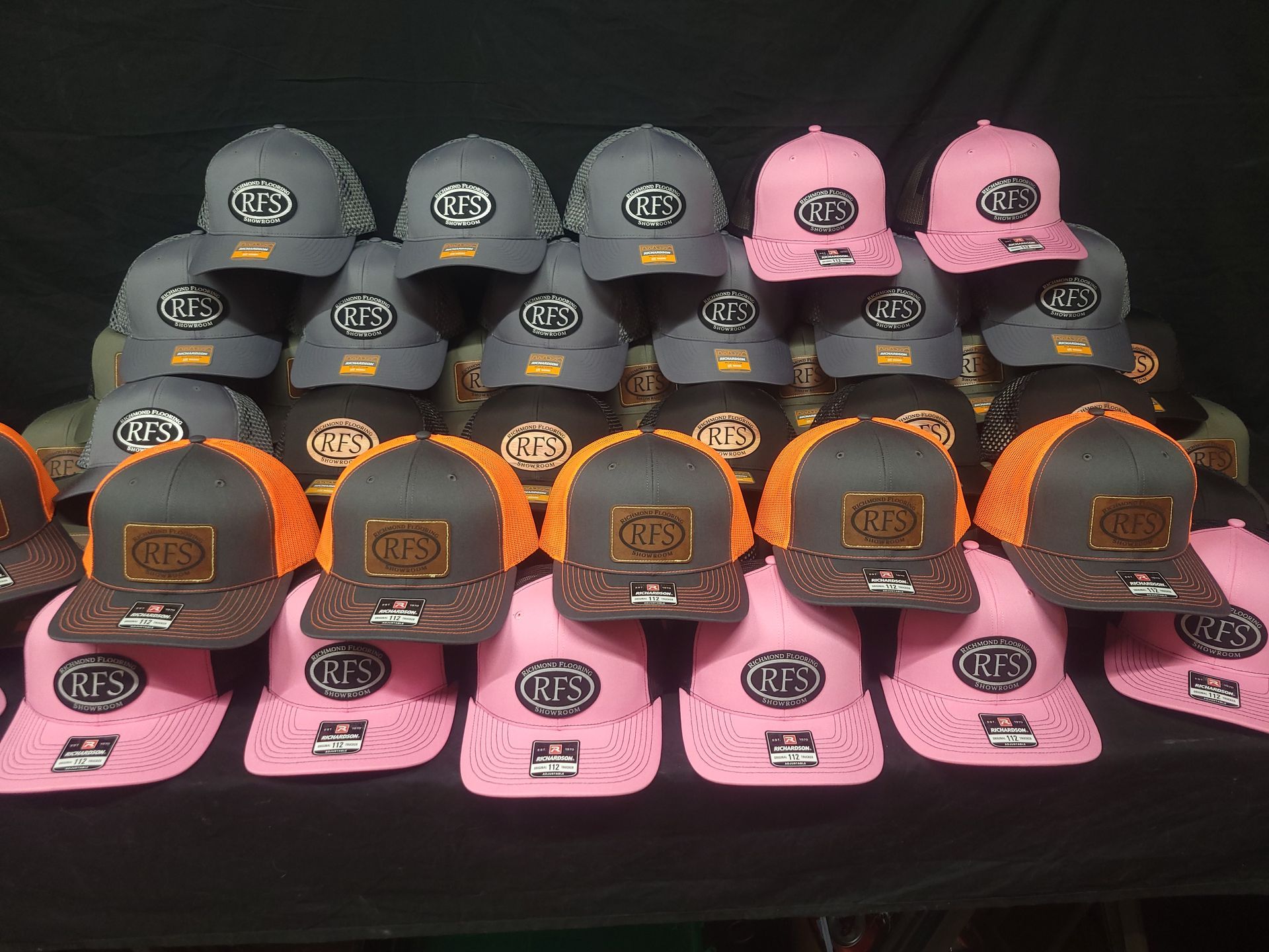 A bunch of hats are lined up on a table