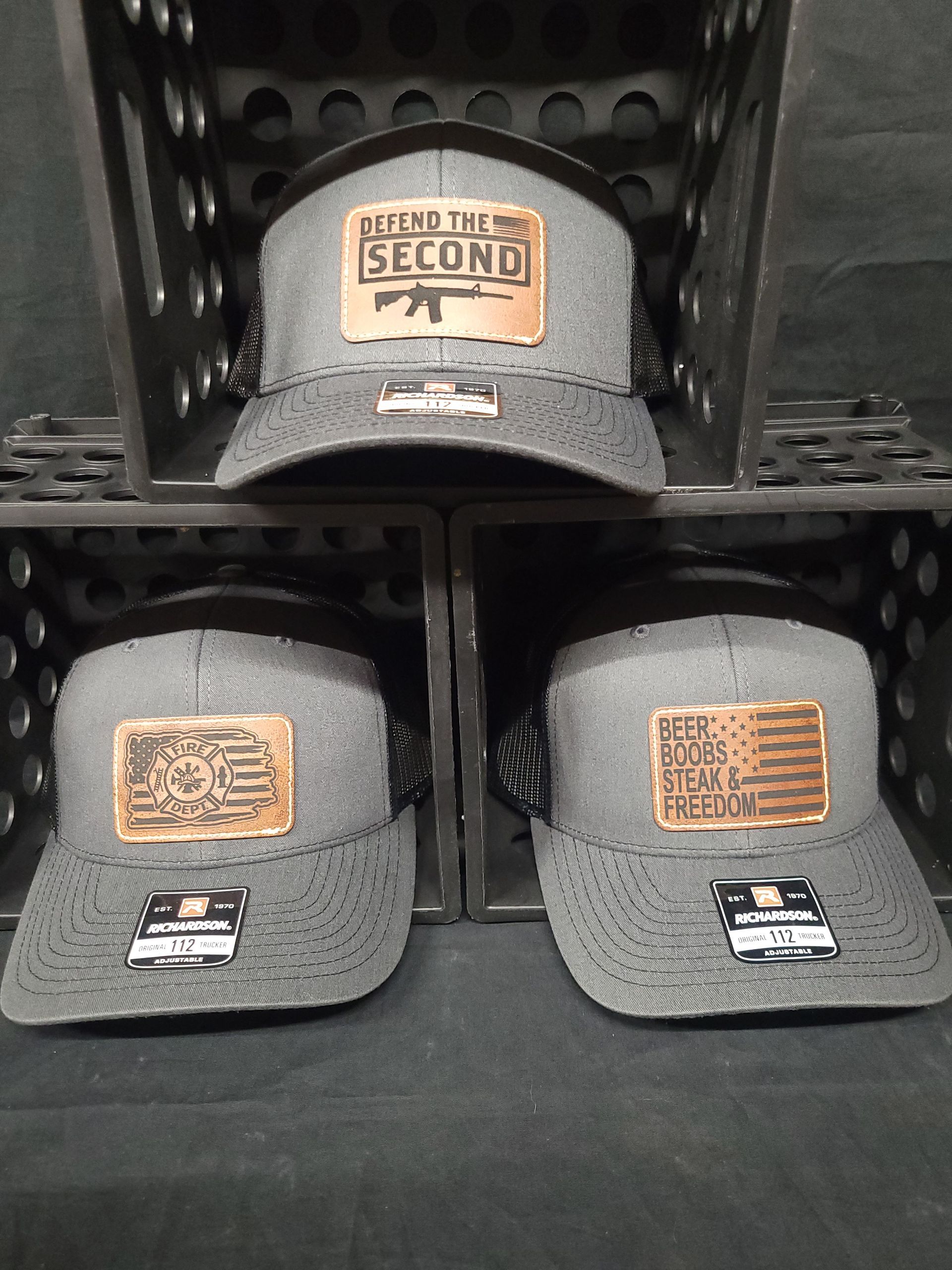 A stack of hats with one that says second on it