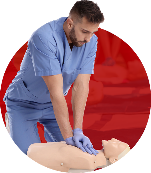Man in blue scrubs performing CPR on a mannequin,