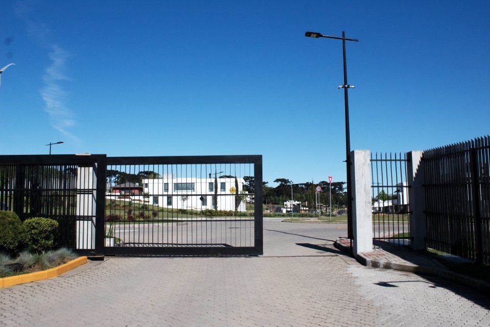 A sliding gate with a blue sky in the background