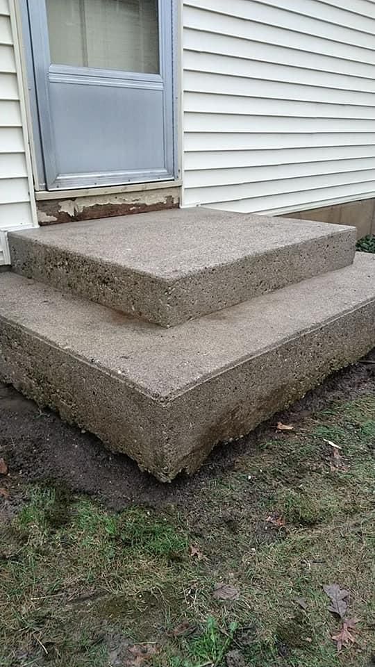 A set of concrete steps leading up to a house.