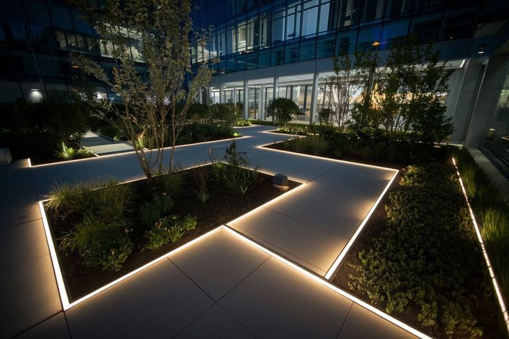 Pathway with illuminated edges in a modern garden at night.