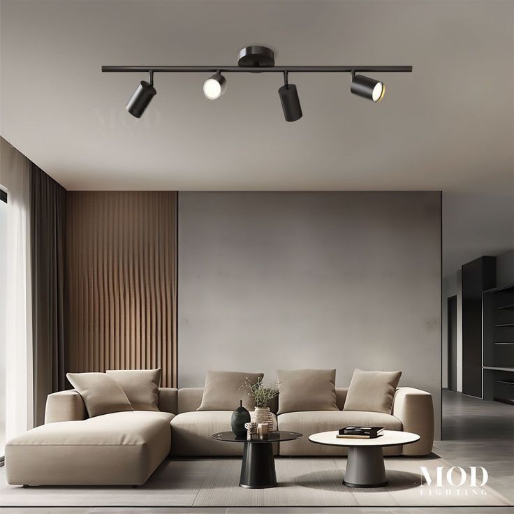 Living room with beige sectional sofa, coffee tables, and track lighting.