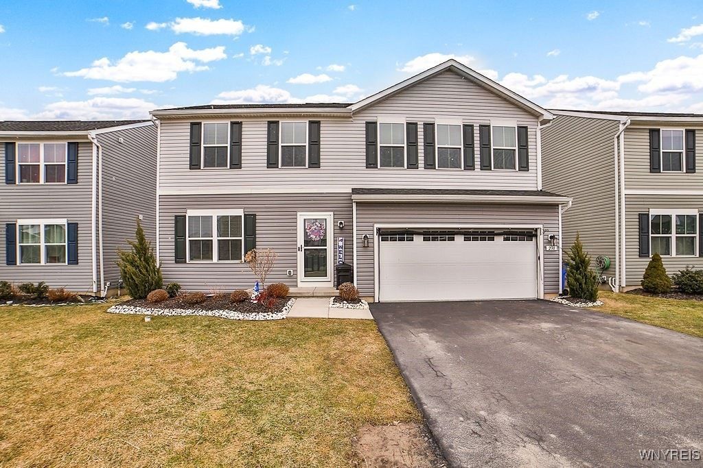 Exterior view of 238 Winterbrook Dr in Amherst—a colonial-style home with attached two-car garage.