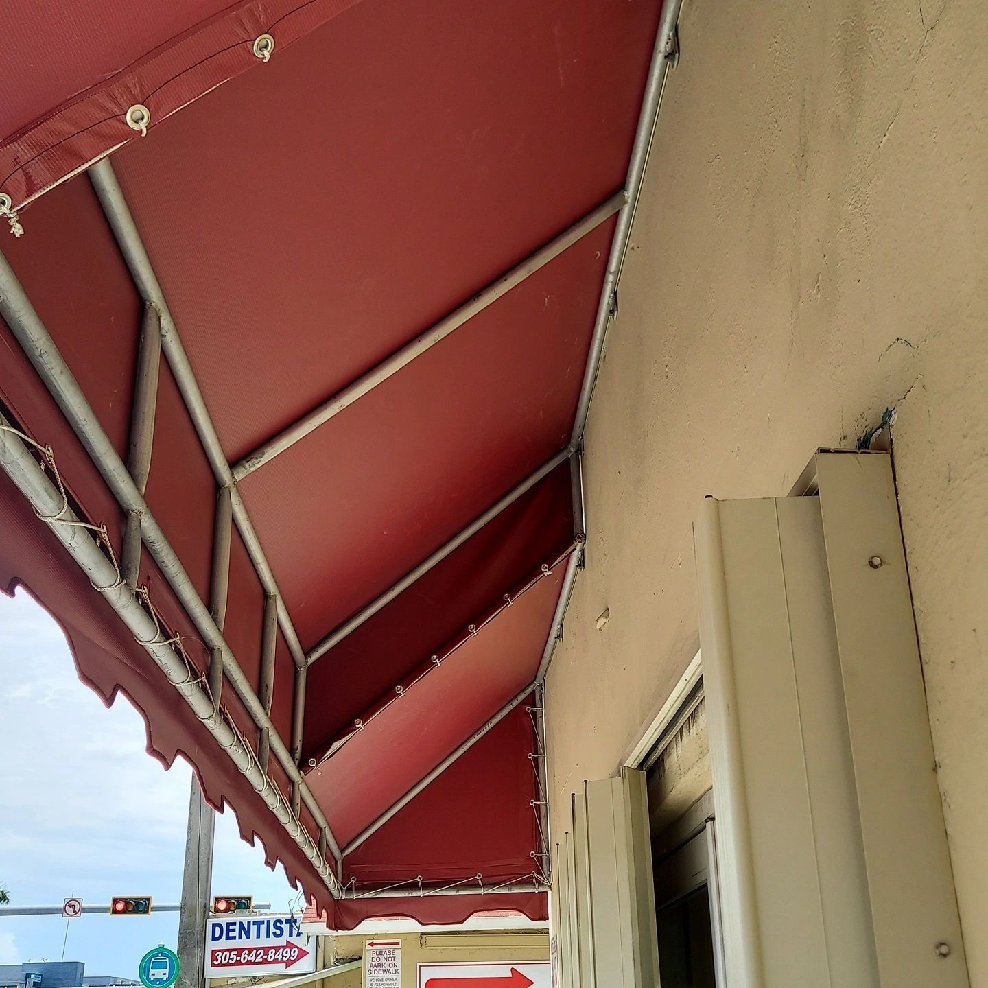 A red awning on the side of a building