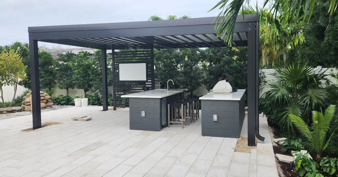 A patio with a pergola and a table and chairs underneath it.