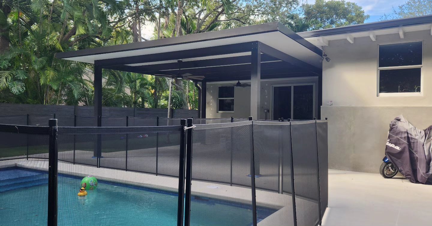 A house with a swimming pool and a fence around it.