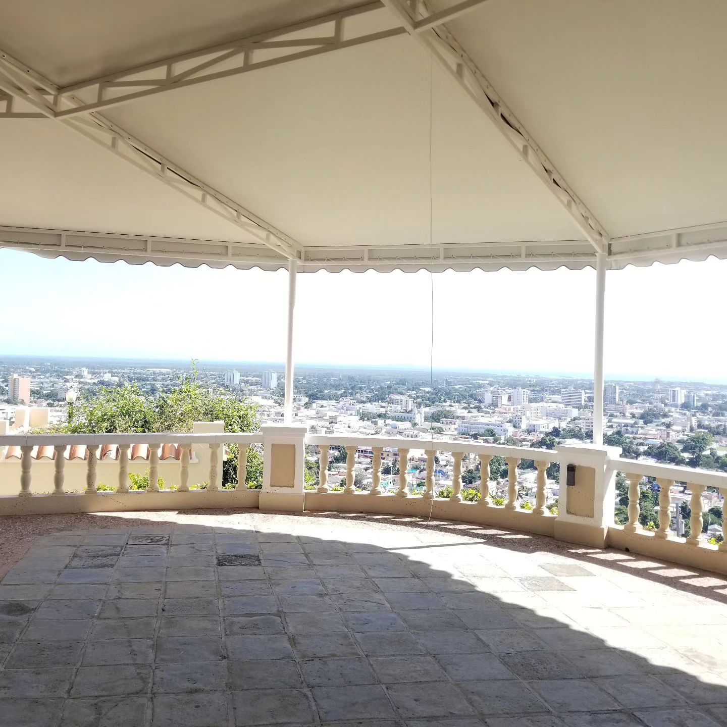 An empty balcony with a view of a city