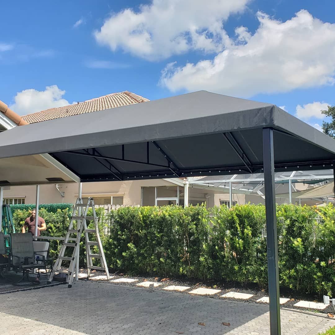 A canopy is being built in the backyard of a house.